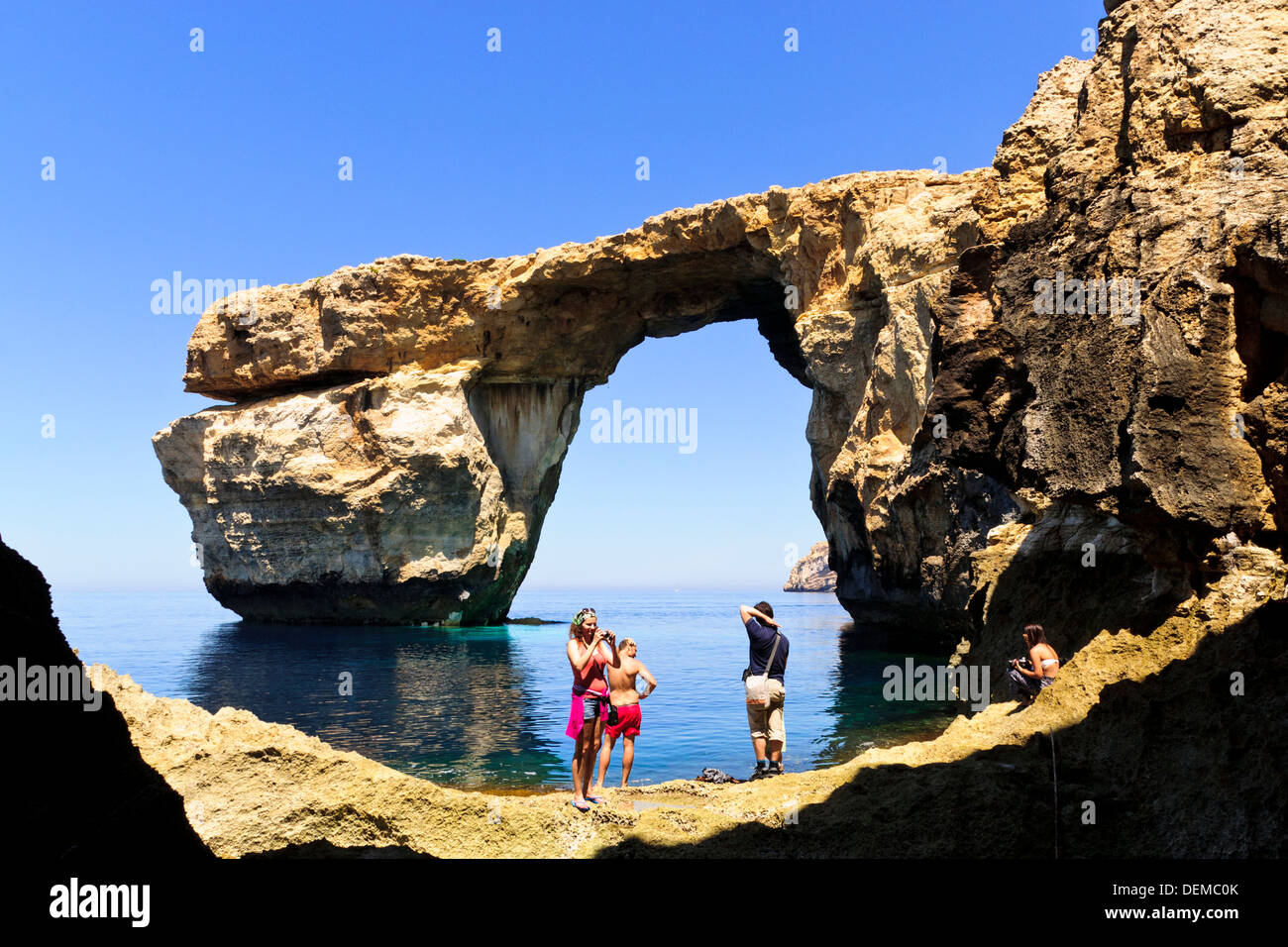 Tourists in front of Azure Window natural arch at Dwerja, Gozo, Malta. Stock Photo