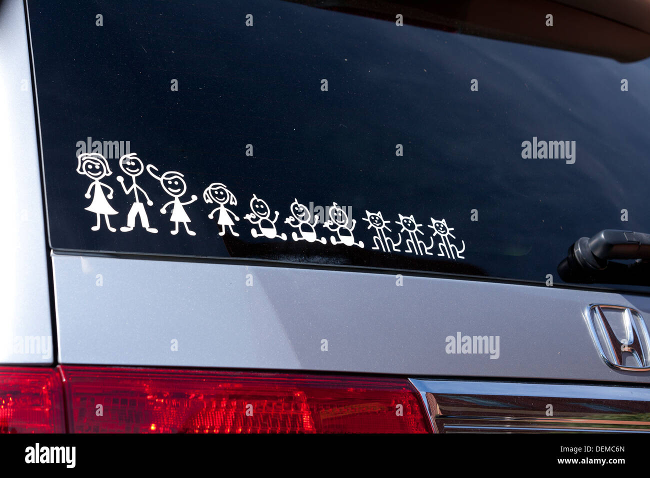 Large family stick figure decal on minivan rear windshield - USA Stock Photo