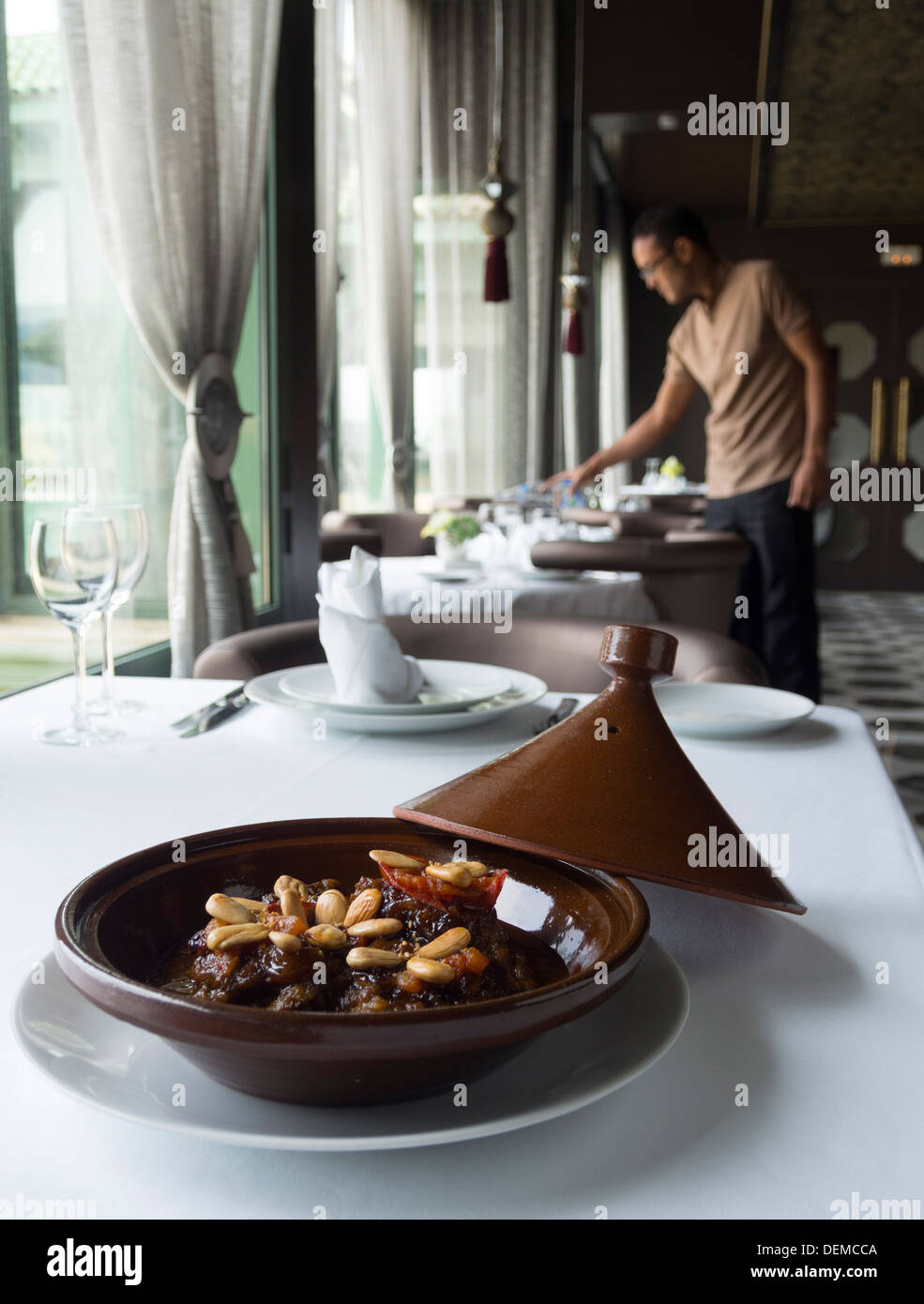 Traditional Moroccan dish tagine on restaurant table Stock Photo