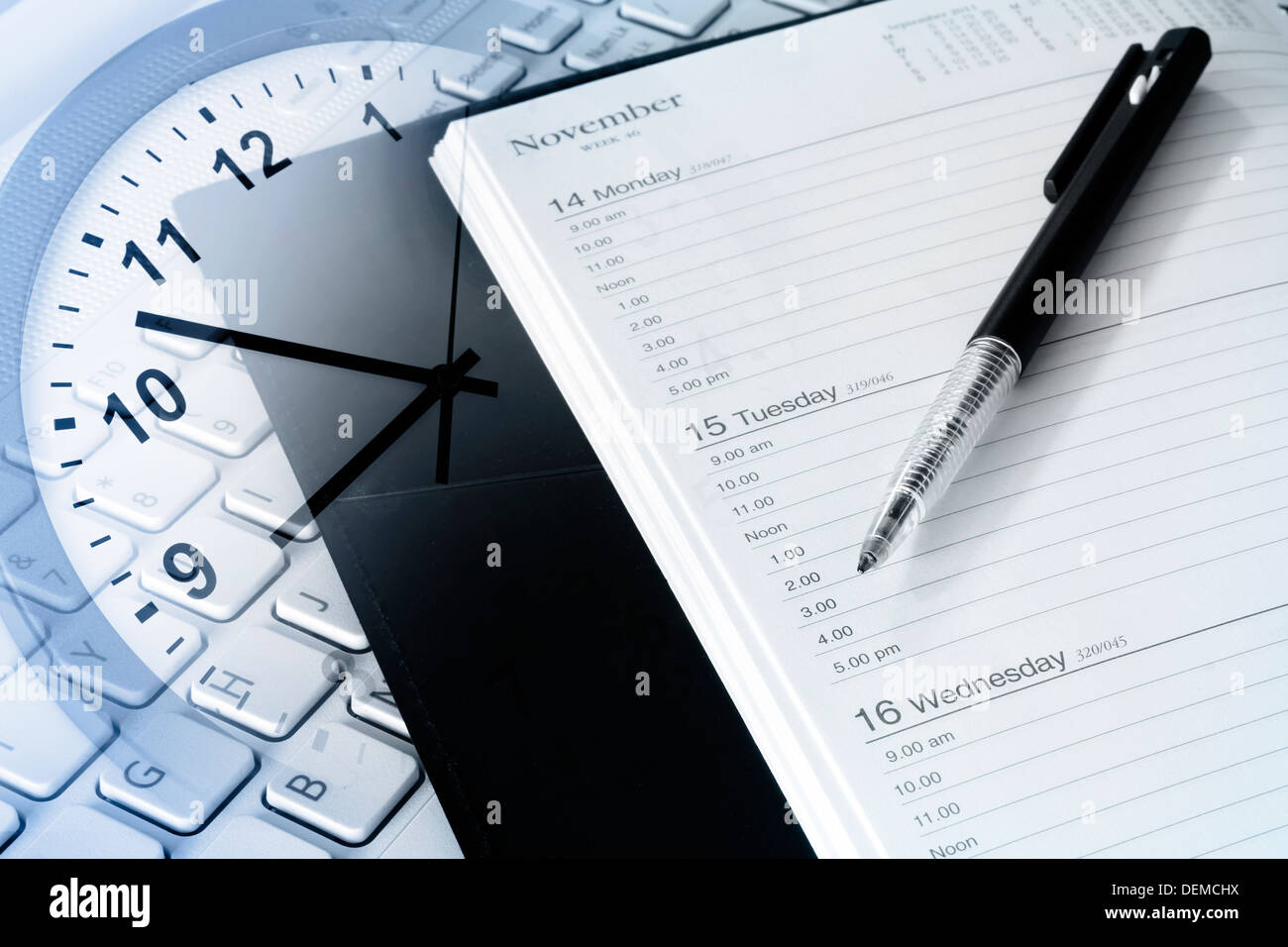 Pen, diary, clock and computer keyboard Stock Photo