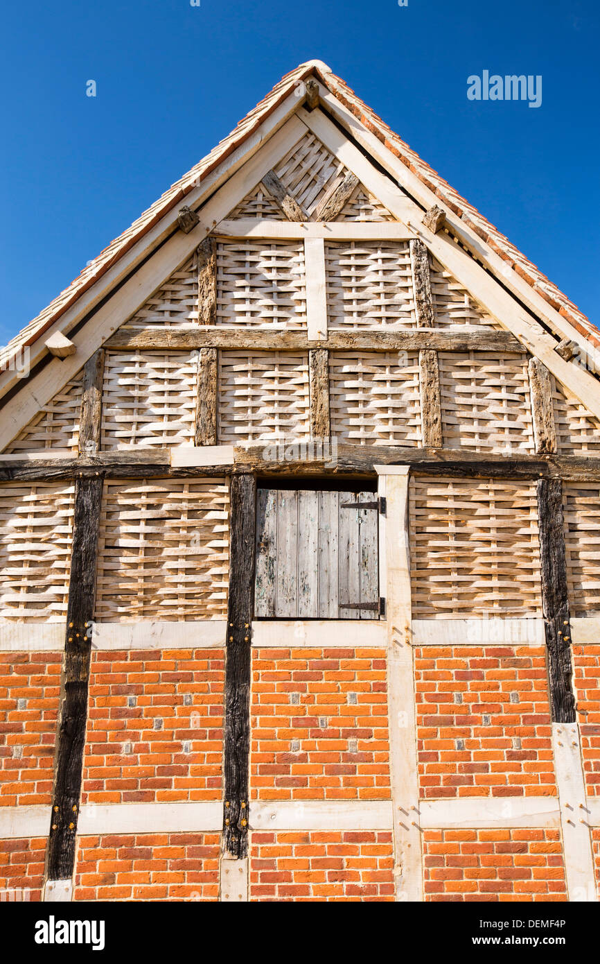 A fantastic old barn with upper walls woven from split timber on a farm in Great Comberton, Vale of Evesham, Worcestershire, UK. Stock Photo