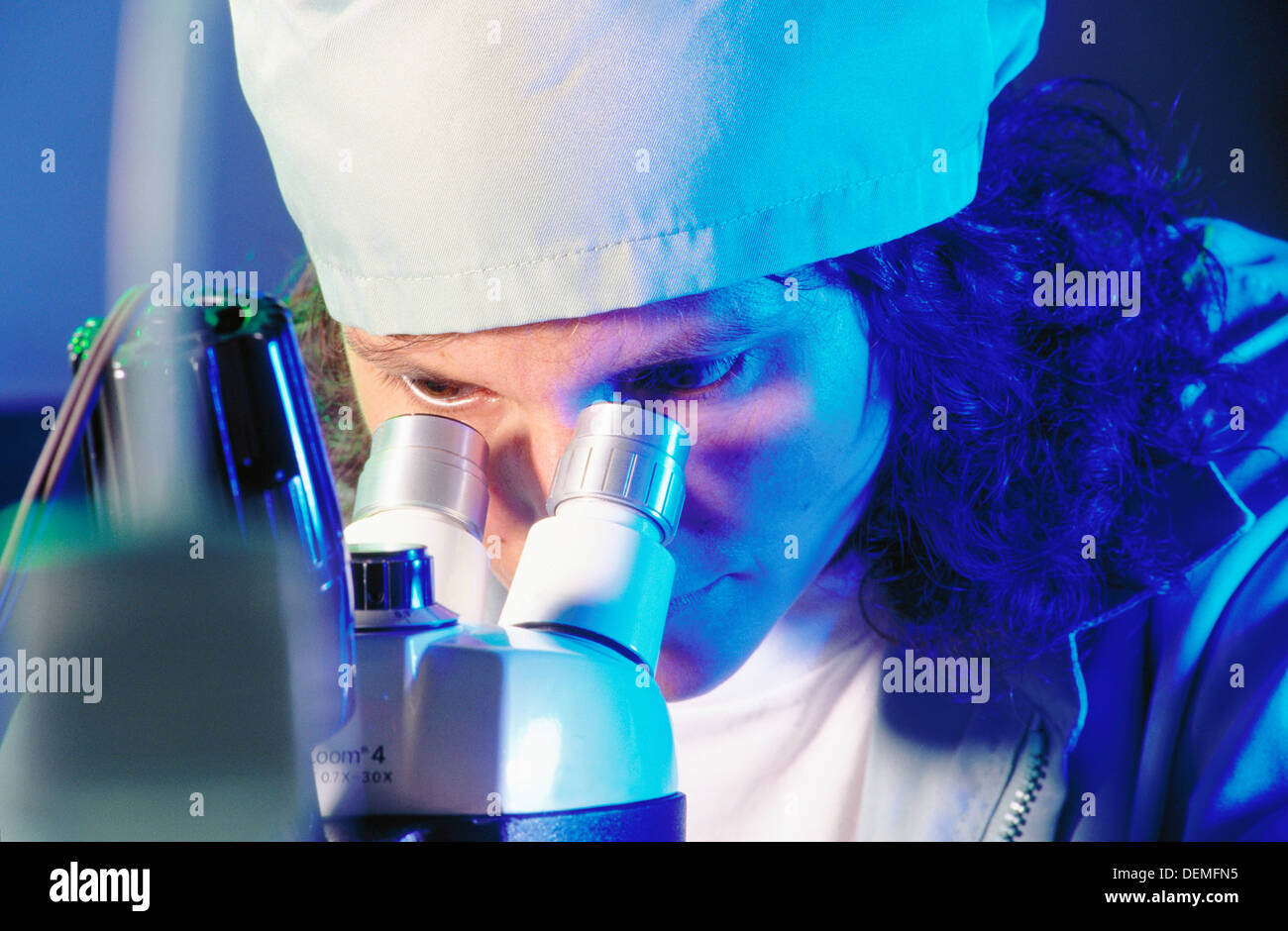 Technician using microscope Stock Photo Alamy