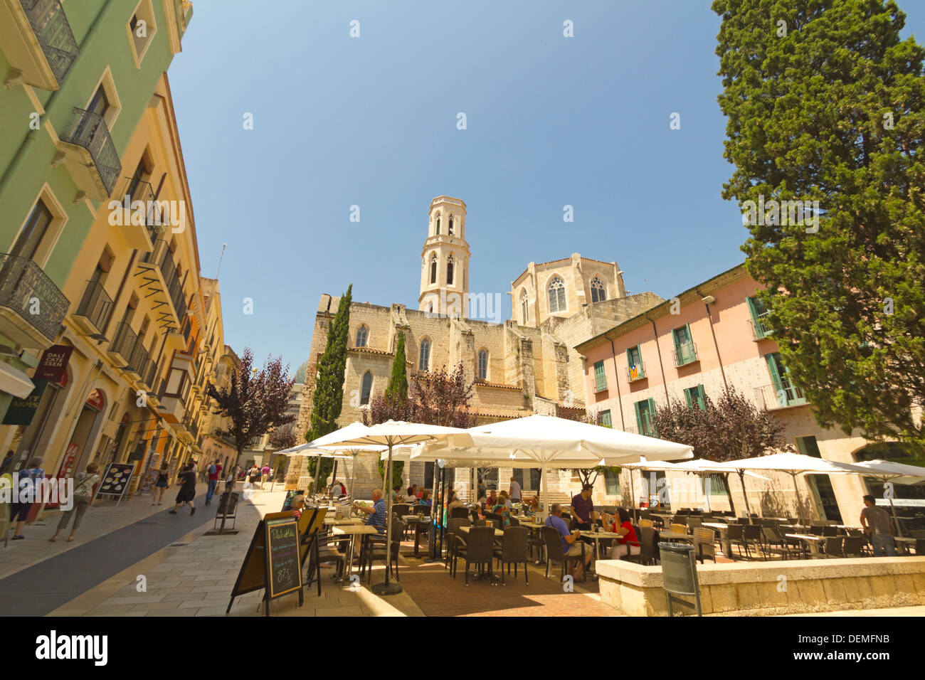 Main square in Figueres, Spain on June 14, 2012. Tourists in the church square in Figueres. In the background, the Dali Museum. Stock Photo