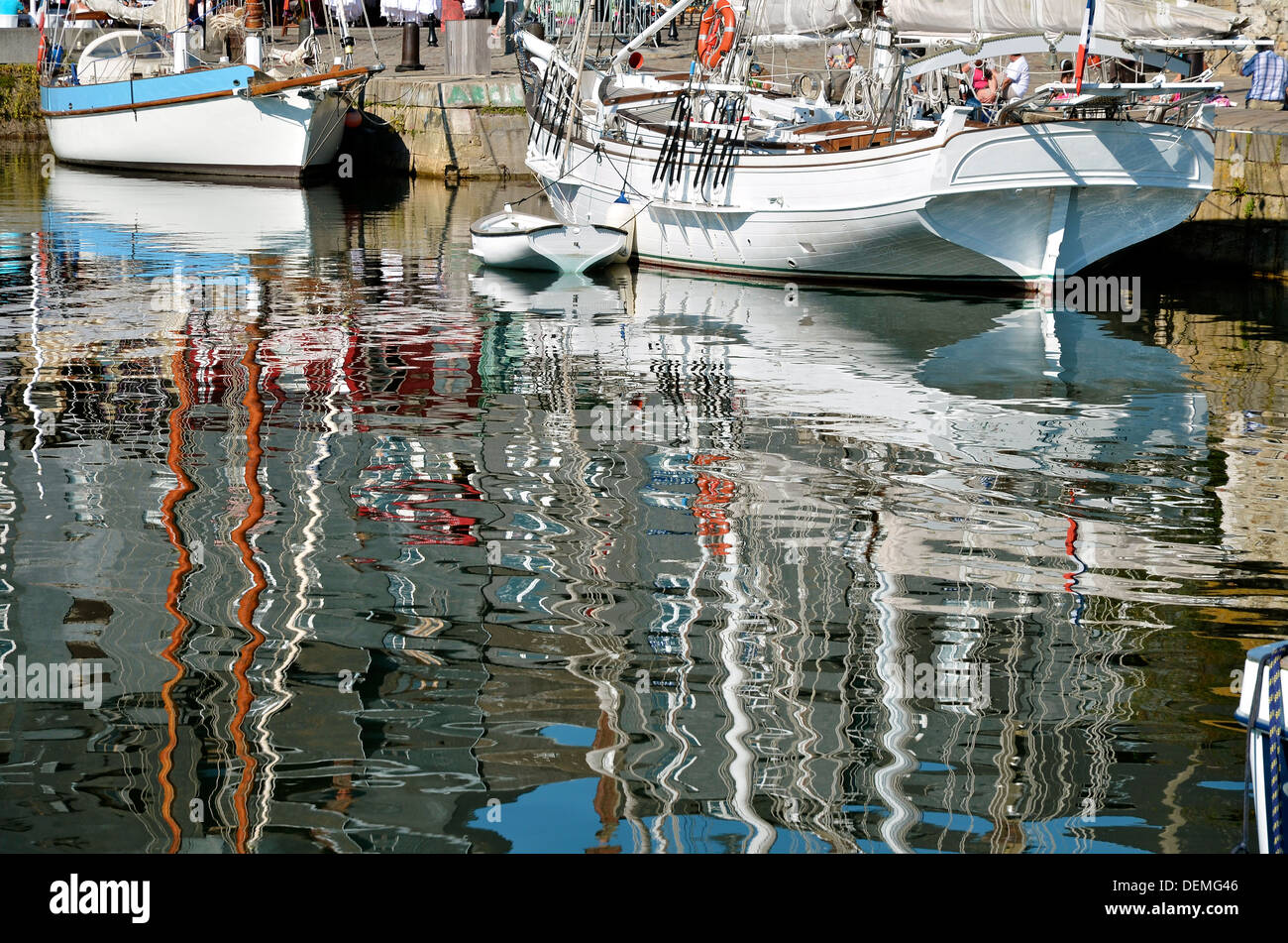 The big reflection of masts and buildings on the sea, in the port of Honfleur, commune in the Calvados department in France Stock Photo