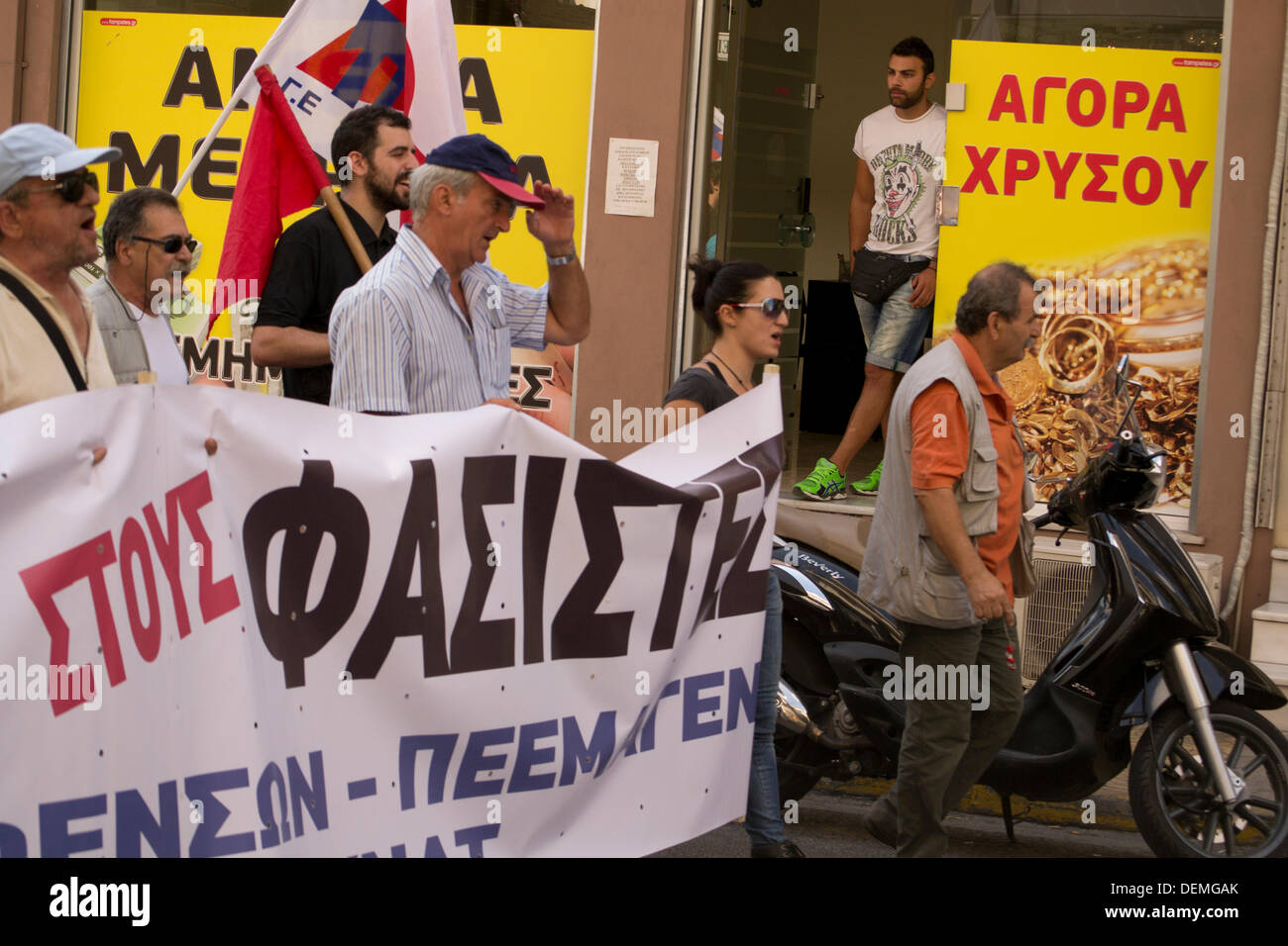 Nikaia, Athens, Greece, September 21st 2013. Following Pavlos Fyssas stabbing to death by a member of the neo-nazi, Golden Dawn party, Union members and leftists stage a demonstration  to protest against fascists. The anti-fascism march passes by a pawn shop. Credit:  Nikolas Georgiou / Alamy Live News Stock Photo