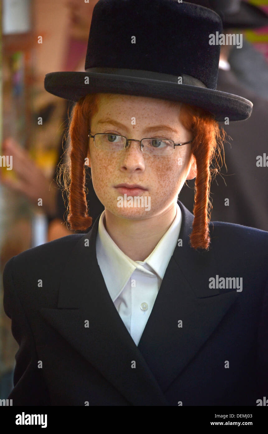 Portrait of an orthodox religious Jewish boy with red hair & sidelocks . In Crown Heights, Brooklyn, NY Stock Photo