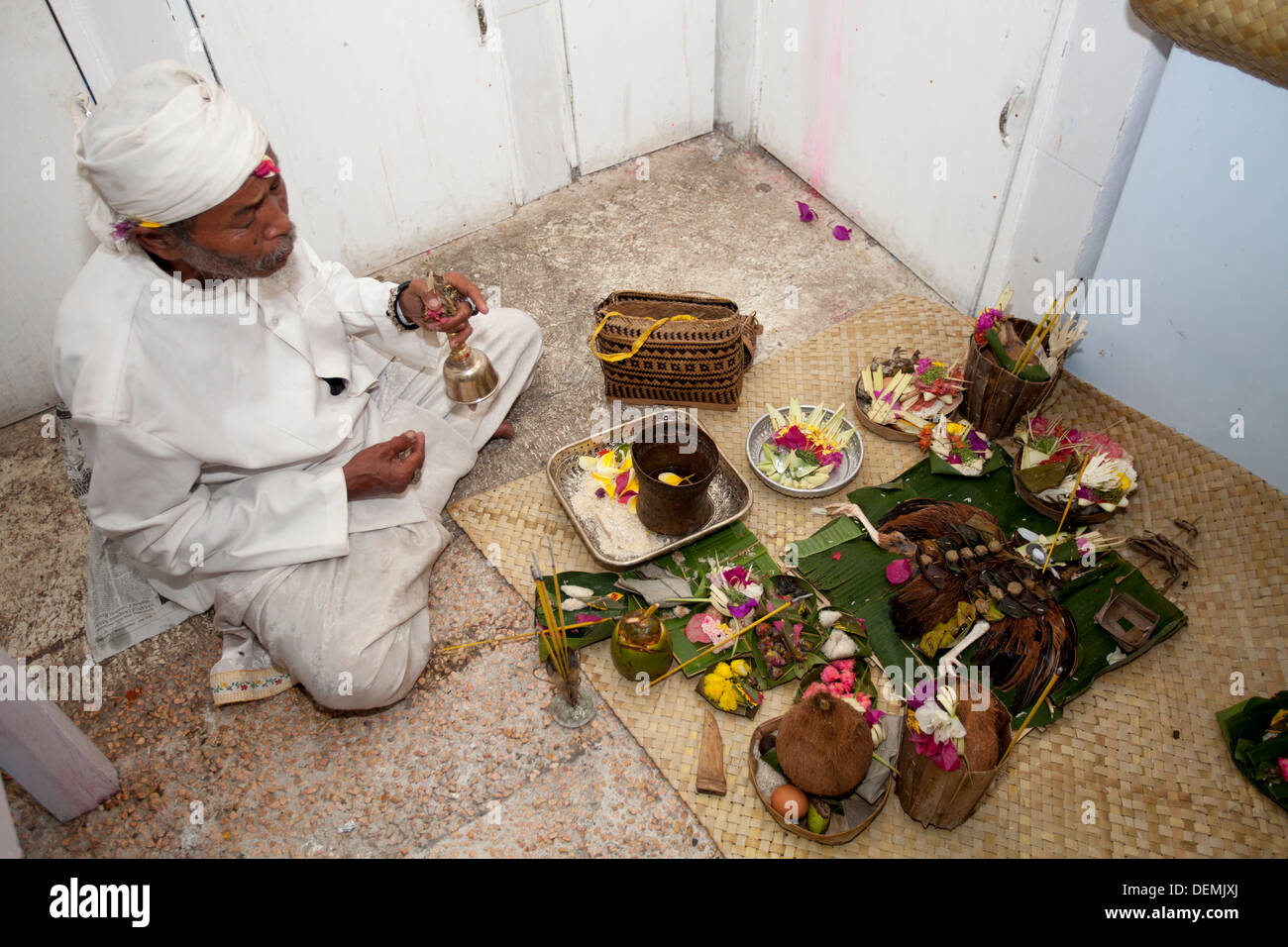 Indonesia Priest blessing new office space kitchen Bali Asia ceremony gods spirits protect protection luck profitable bless art Stock Photo