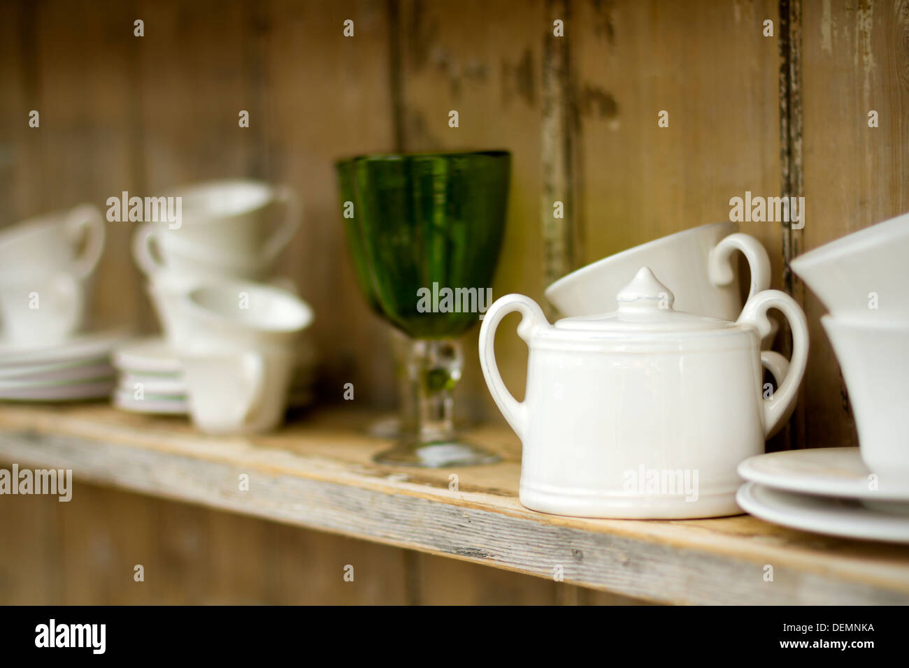 Shelf with a mix of cups and glasses with added vignette and shallow DOF Stock Photo