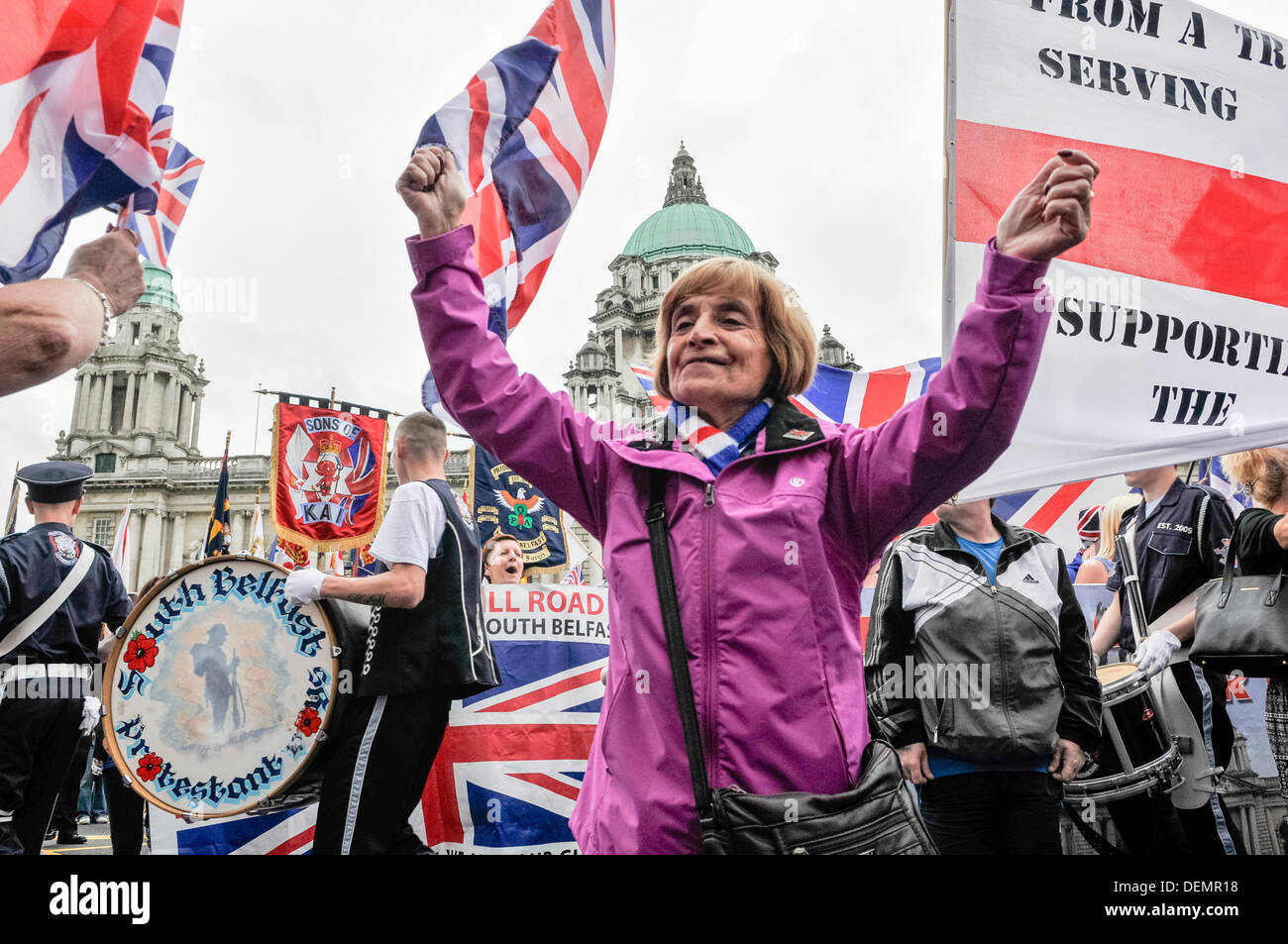 Belfast, Northern Ireland, 21st September 2013 - A 'flag protester' waves a union flag and dances in the parade. Credit:  Stephen Barnes/Alamy Live News Stock Photo