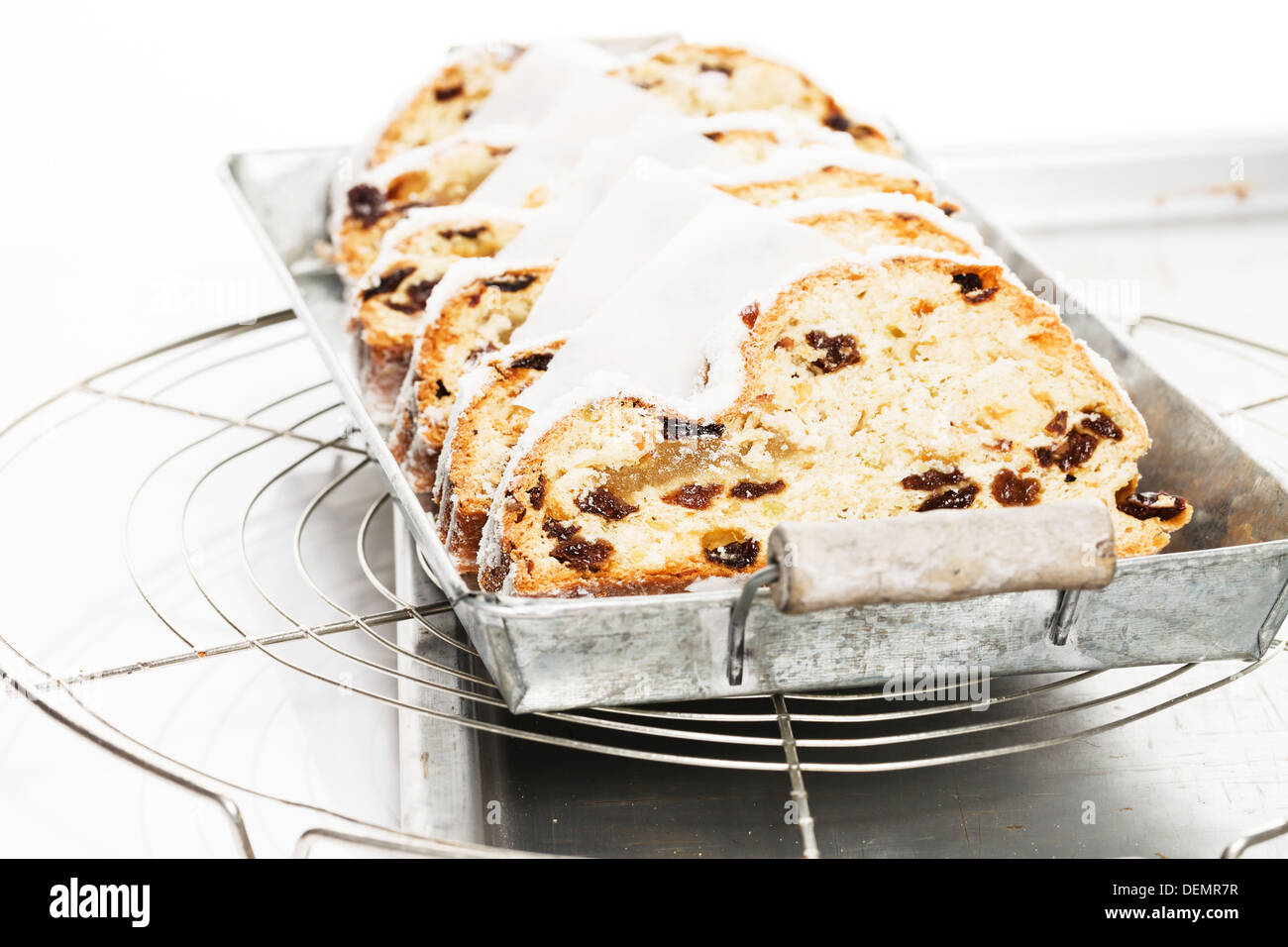 traditional christmas stollen cake on a rustic metal tray on a cooling grid Stock Photo