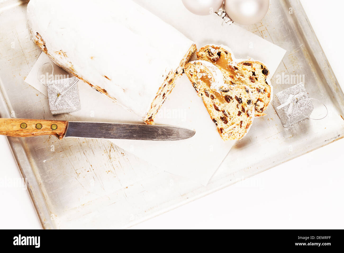 christmas stollen cake with a knife on a silver metal tray from top Stock Photo