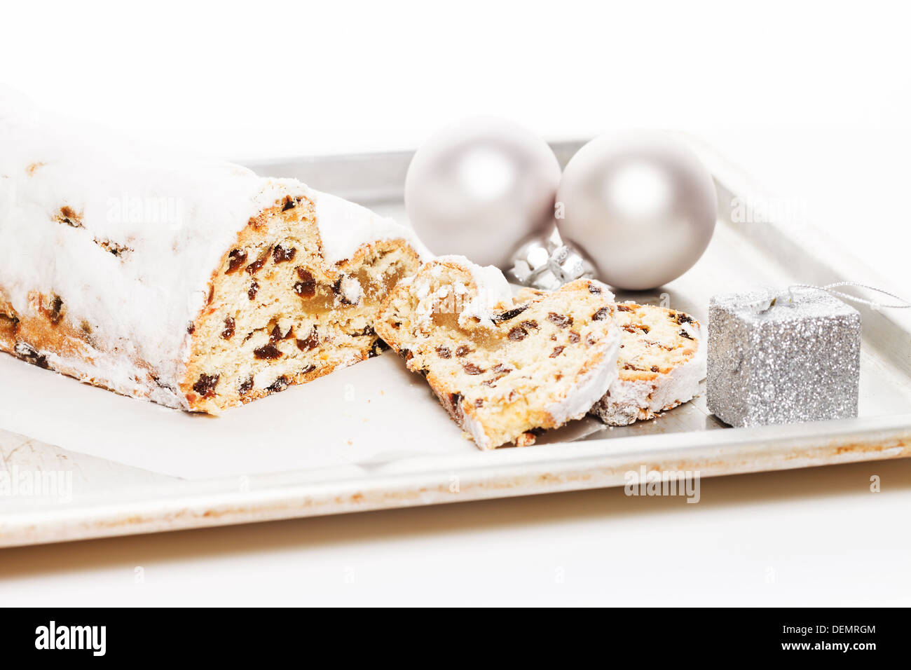 stollen cake for christmas on a silver metal tray with a silver christmas balls and small christmas present Stock Photo