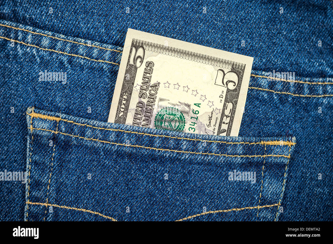 Five dollar bill in the back jeans pocket Stock Photo - Alamy