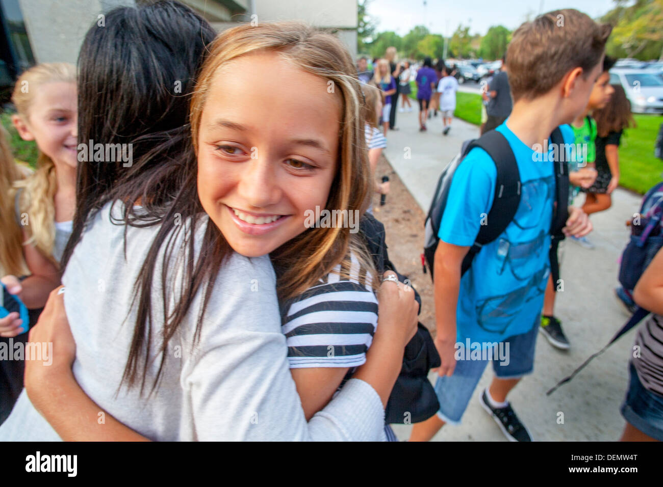 Multiethnic middle school students greet each other on the first day of school in Aliso Viejo, CA. Stock Photo