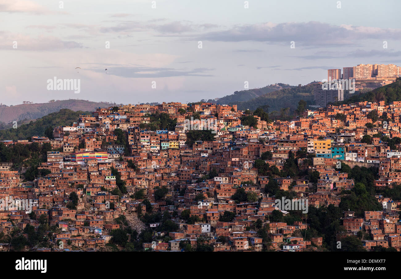 CARACAS - CIRCA 2013: Barrios and favelas in Caracas and paragliding Stock Photo