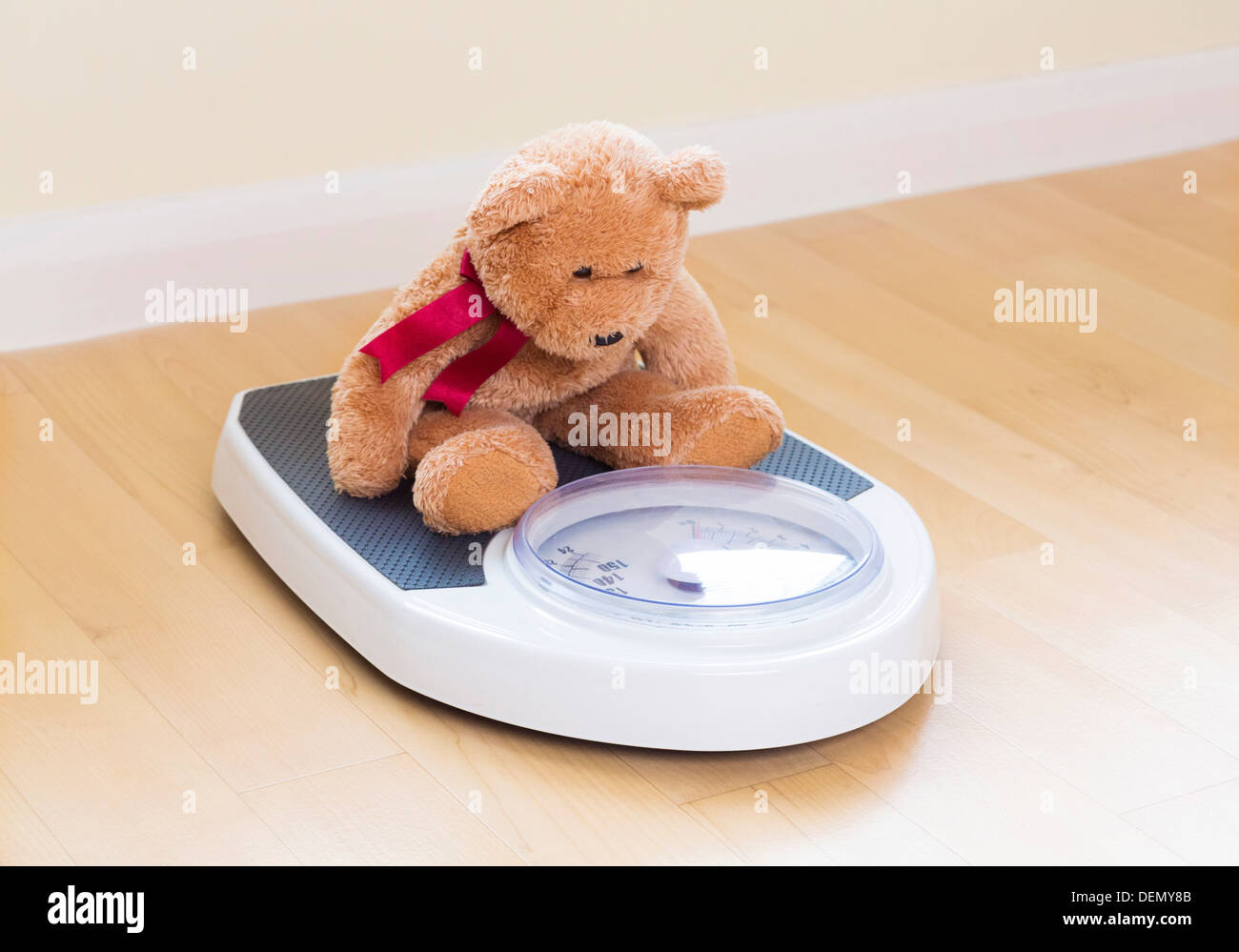 teddy bear on weighing scales Stock Photo