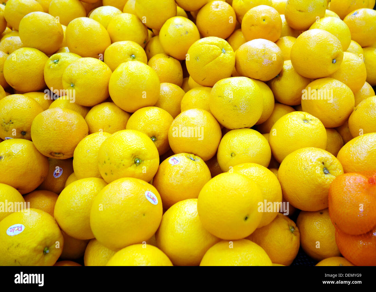 Yellow oranges on a supermarket shelf Stock Photo