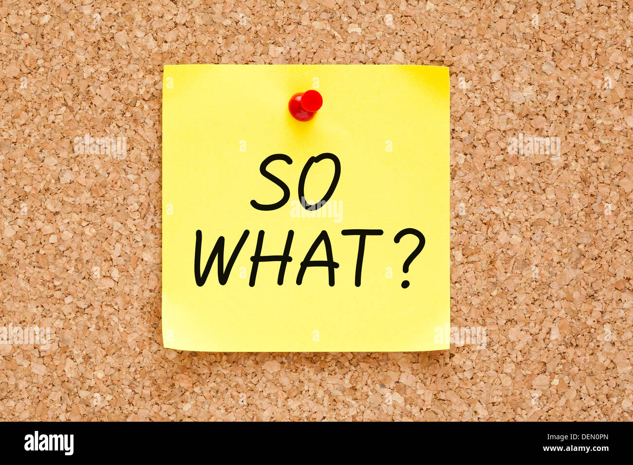 So What, written on an yellow sticky note pinned on a cork bulletin board. Stock Photo