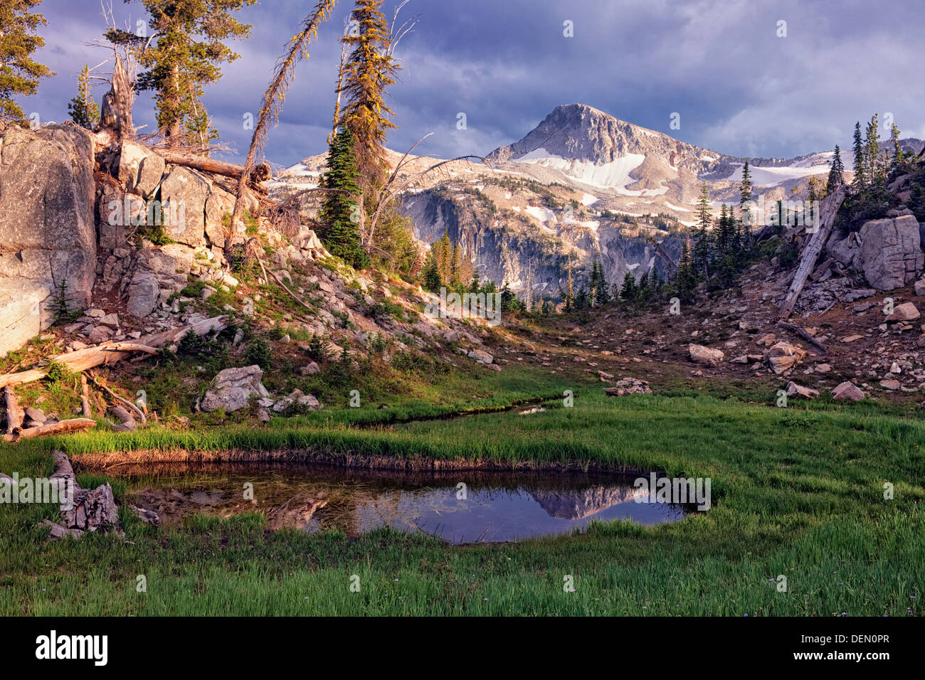 Evening storm approaches tarn reflection of Eagle Cap in the Lakes Basin of NE Oregon's Eagle Cap Wilderness. Stock Photo