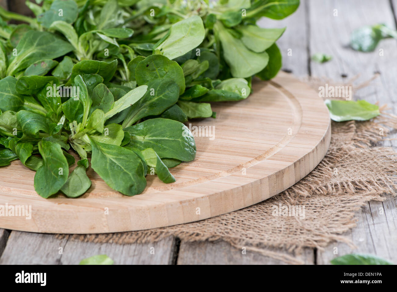 Fresh Lamb's Lettuce on wooden background Stock Photo