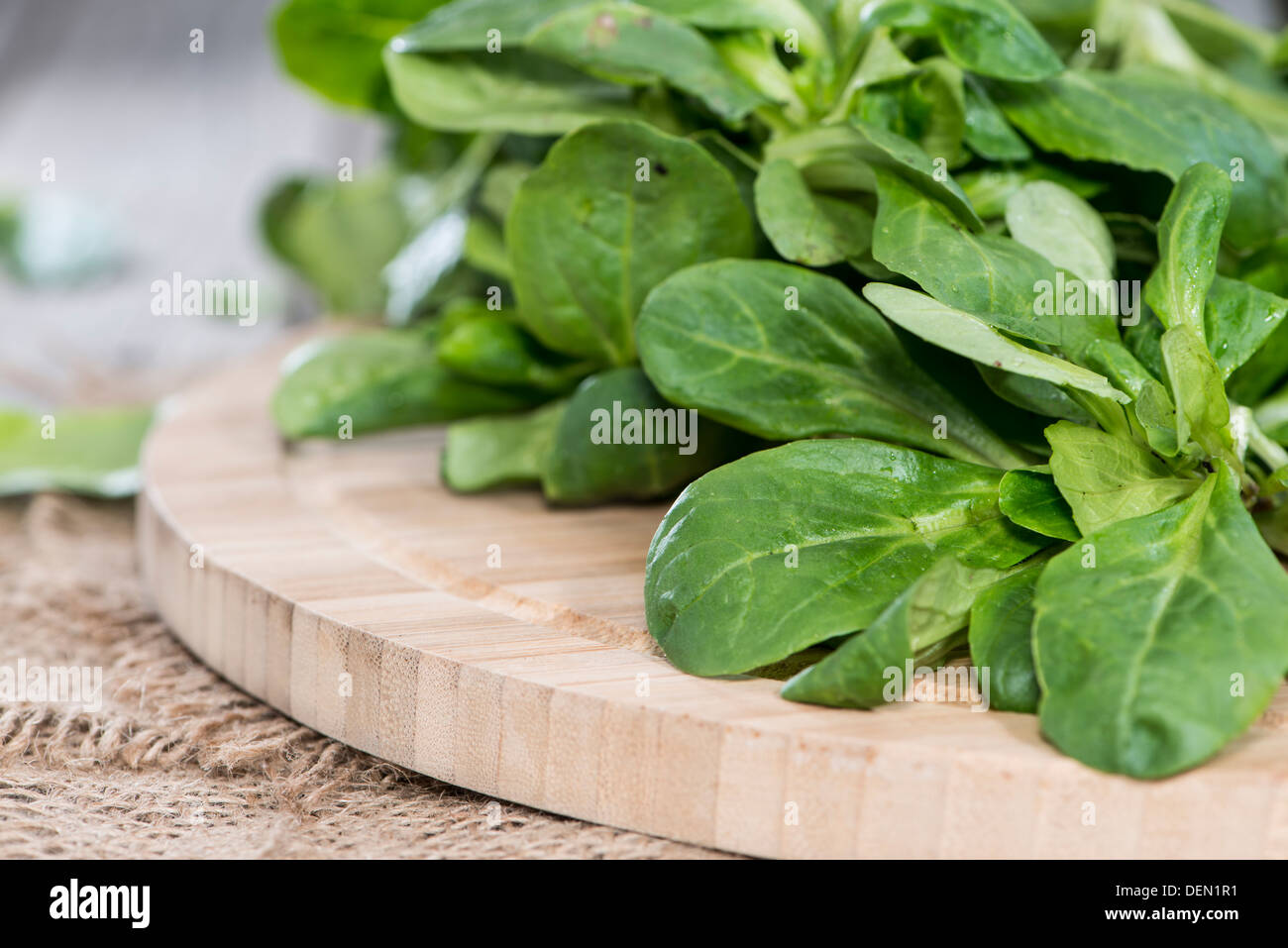Portion of Lamb's Lettuce on vintage wooden background Stock Photo