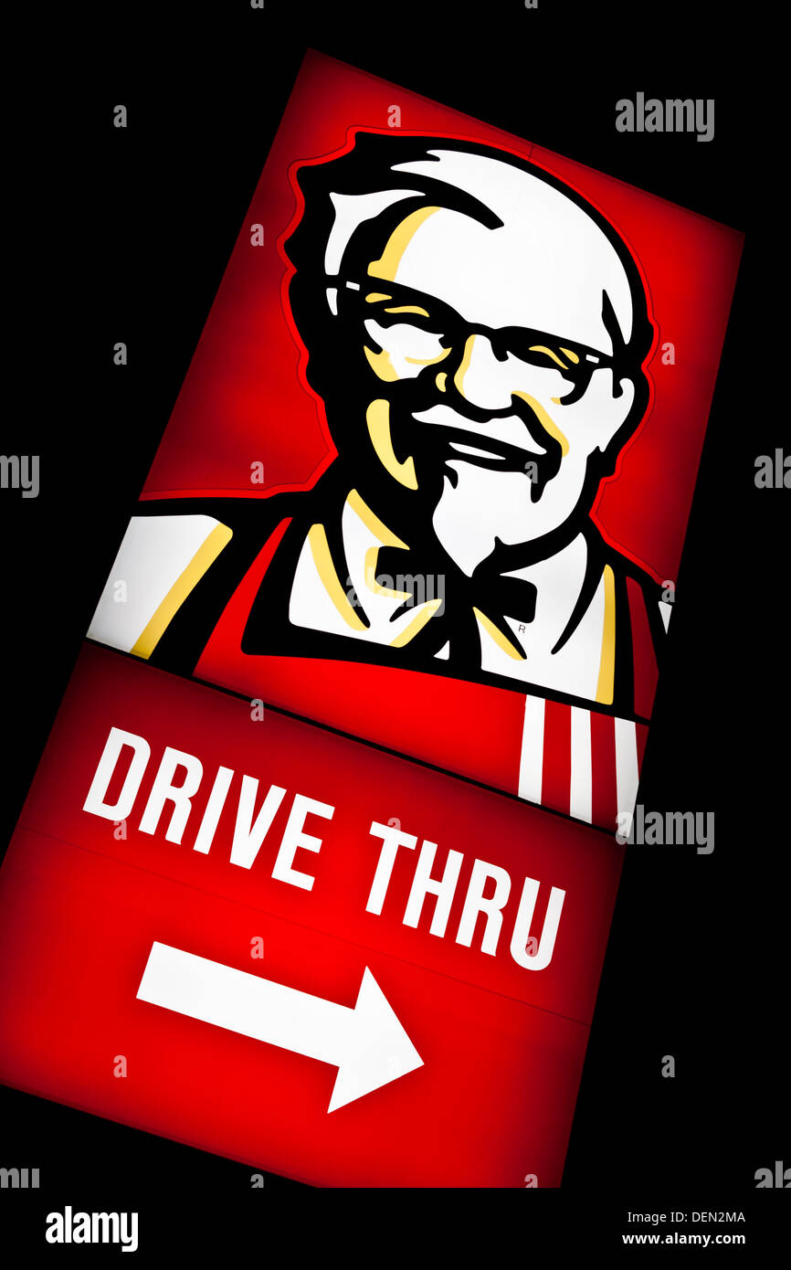 Kentucky Fried Chicken drive through sign lit at night. Stock Photo
