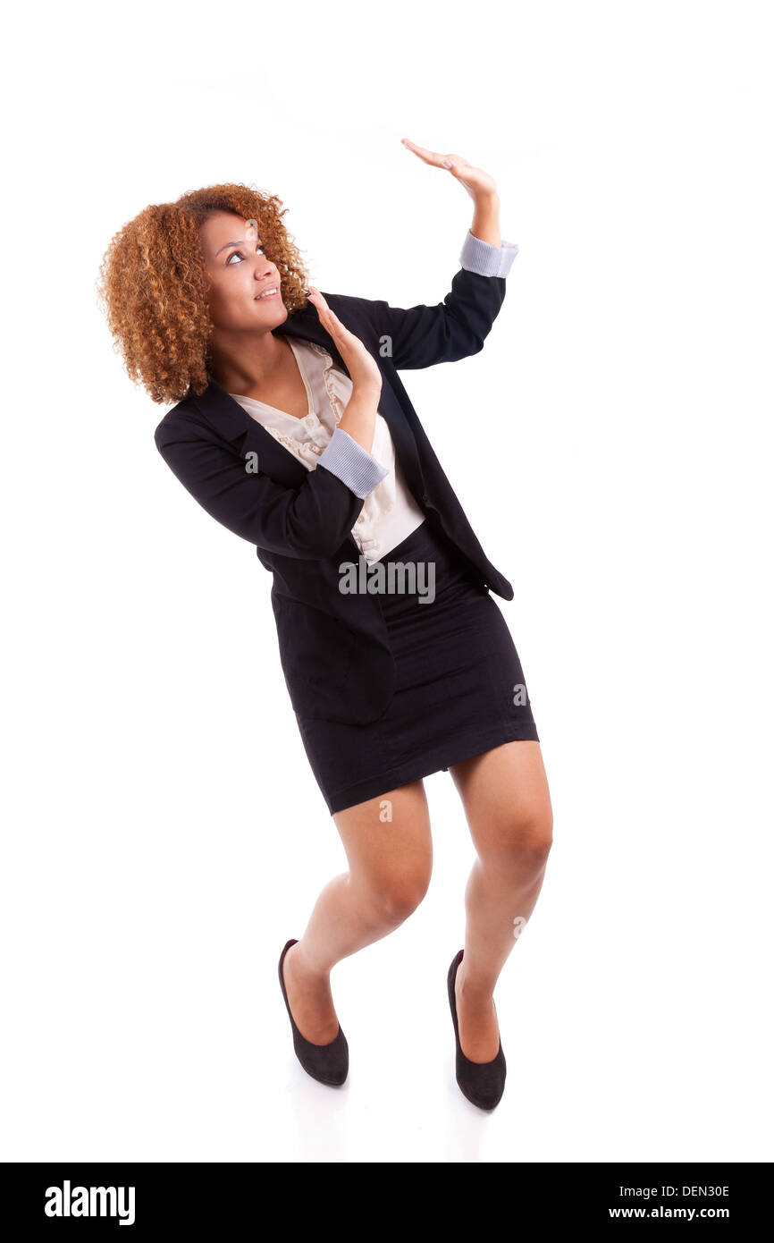 Portrait of a young african american business woman making a protection gesture, isolated on white background - Black people Stock Photo