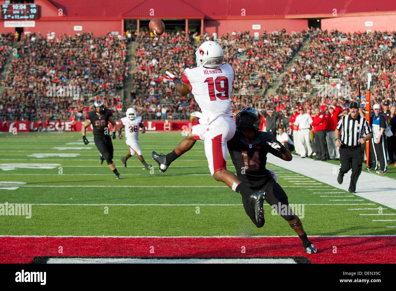 Piscataway, New Jersey, USA. 21st Sep, 2013. September 21, 2013: Arkansas Razorbacks wide receiver Javontee Herndon (19) brings down a touchdown reception as he is defended by Rutgers Scarlet Knights cornerback Nadir Barnwell (14)during the game between Arkansas Razorbacks and Rutgers Scarlet Knights at Highpoint Solutions Stadium in Piscataway, NJ. Rutgers Scarlet Knights defeated The Arkansas Razorbacks 28-24. Credit:  csm/Alamy Live News Stock Photo