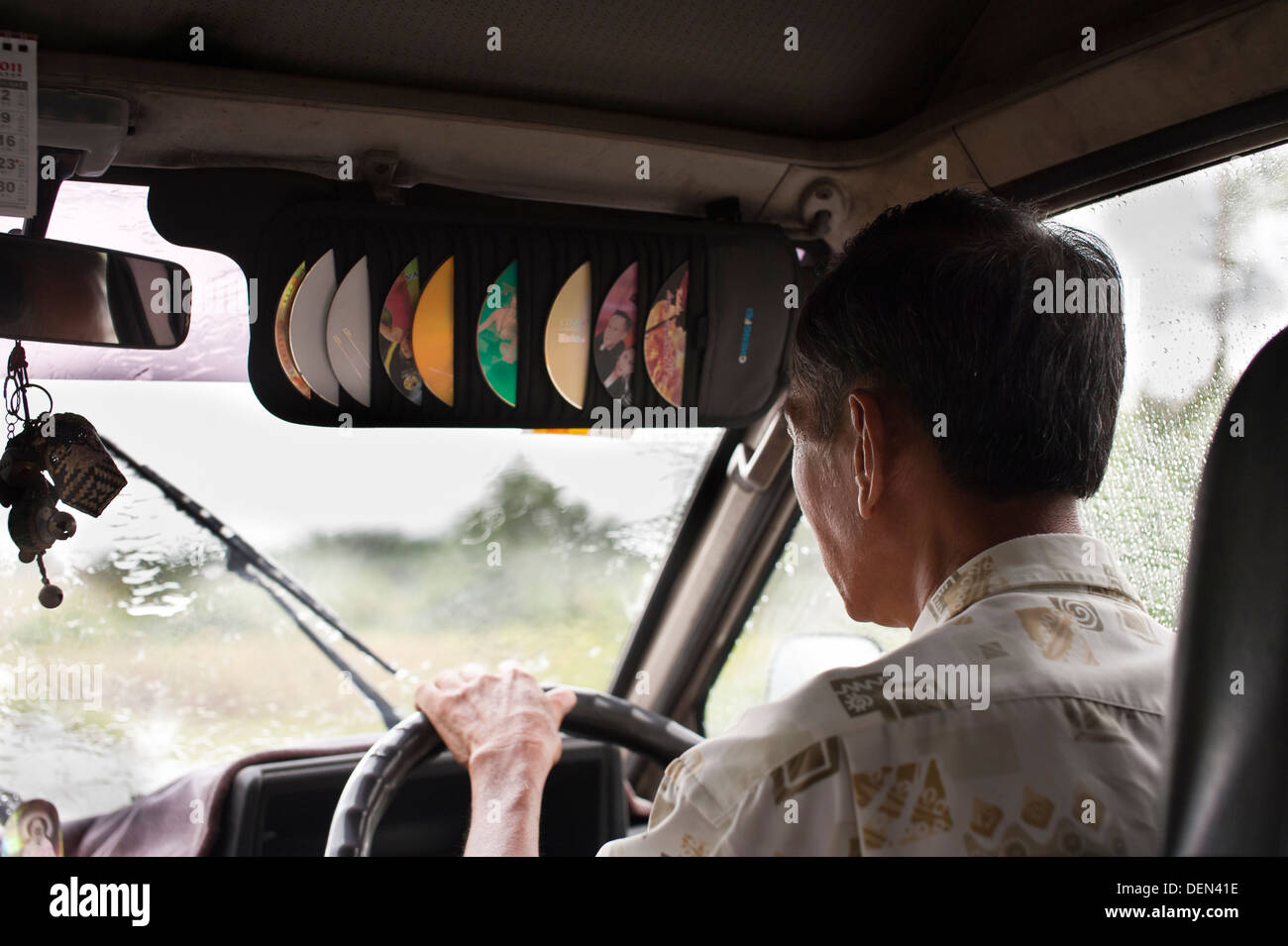 Van driver negotiating tropical downpour, Sarawak, Malaysia Stock Photo