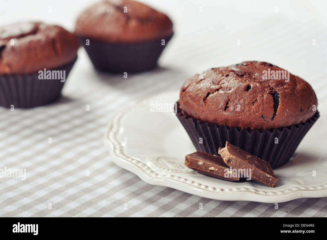 Chocolate Muffins on checkered tablecloth closeup Stock Photo