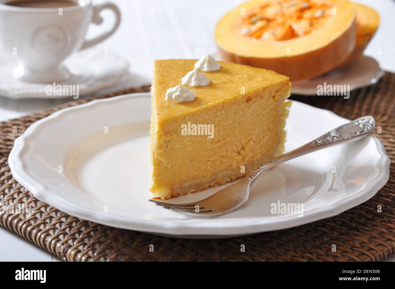 Fresh Homemade Pumpkin Pie with whipped cream on white plate closeup Stock Photo
