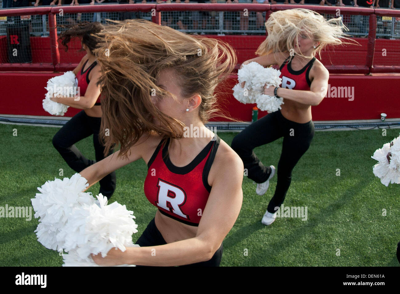 Piscataway, New Jersey, USA. 21st Sep, 2013. September 21, 2013: A Rutgers Scarlet Knights cheerleader has her hair whip around her face during the game between Arkansas Razorbacks and Rutgers Scarlet Knights at Highpoint Solutions Stadium in Piscataway, NJ. Rutgers Scarlet Knights defeated The Arkansas Razorbacks 28-24. Credit:  csm/Alamy Live News Stock Photo