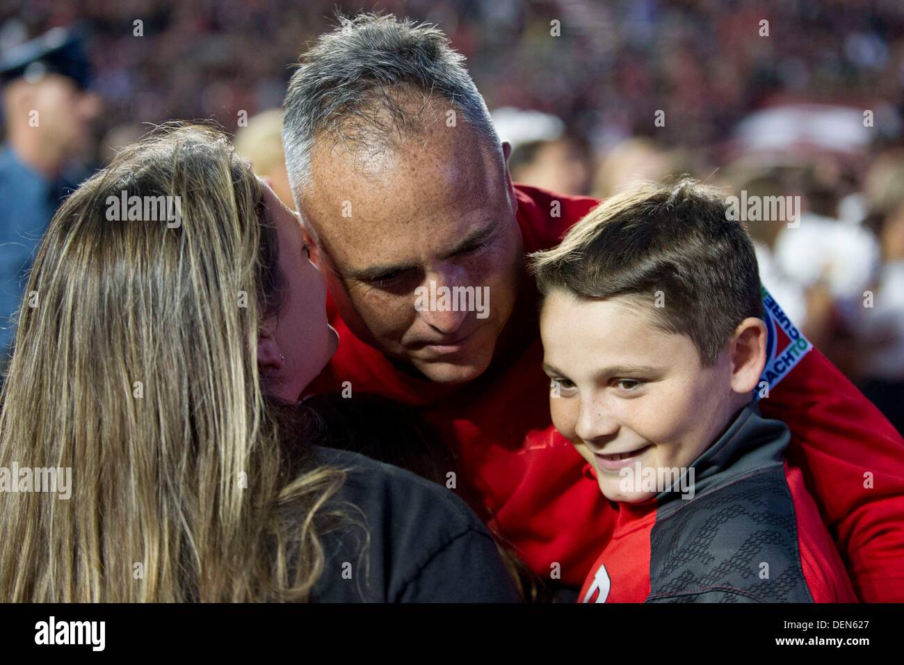 Piscataway, New Jersey, USA. 21st Sep, 2013. September 21, 2013: Rutgers Scarlet Knights head coach Kyle Flood gets a hug and a kiss from his wife and son after the game between Arkansas Razorbacks and Rutgers Scarlet Knights at Highpoint Solutions Stadium in Piscataway, NJ. Rutgers Scarlet Knights defeated The Arkansas Razorbacks 28-24. Credit:  csm/Alamy Live News Stock Photo