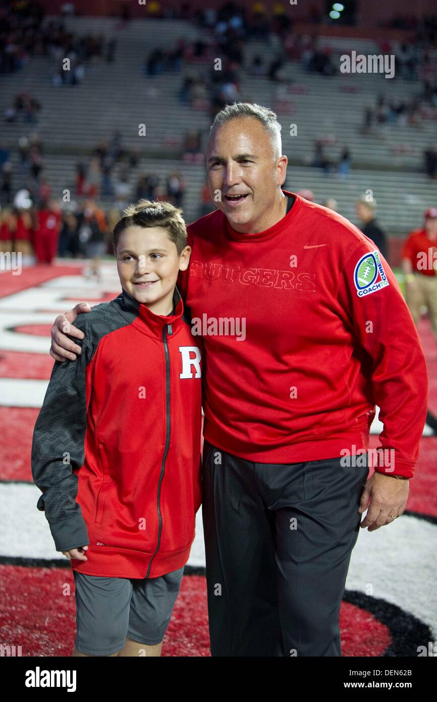 Piscataway, New Jersey, USA. 21st Sep, 2013. September 21, 2013: Rutgers Scarlet Knights head coach Kyle Flood hugs his son after the game between Arkansas Razorbacks and Rutgers Scarlet Knights at Highpoint Solutions Stadium in Piscataway, NJ. Rutgers Scarlet Knights defeated The Arkansas Razorbacks 28-24. Credit:  csm/Alamy Live News Stock Photo