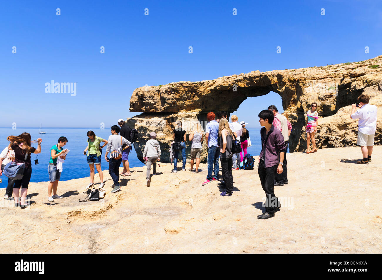 Tourists in front of Azure Window natural arch at Dwerja, Gozo, Malta. Stock Photo