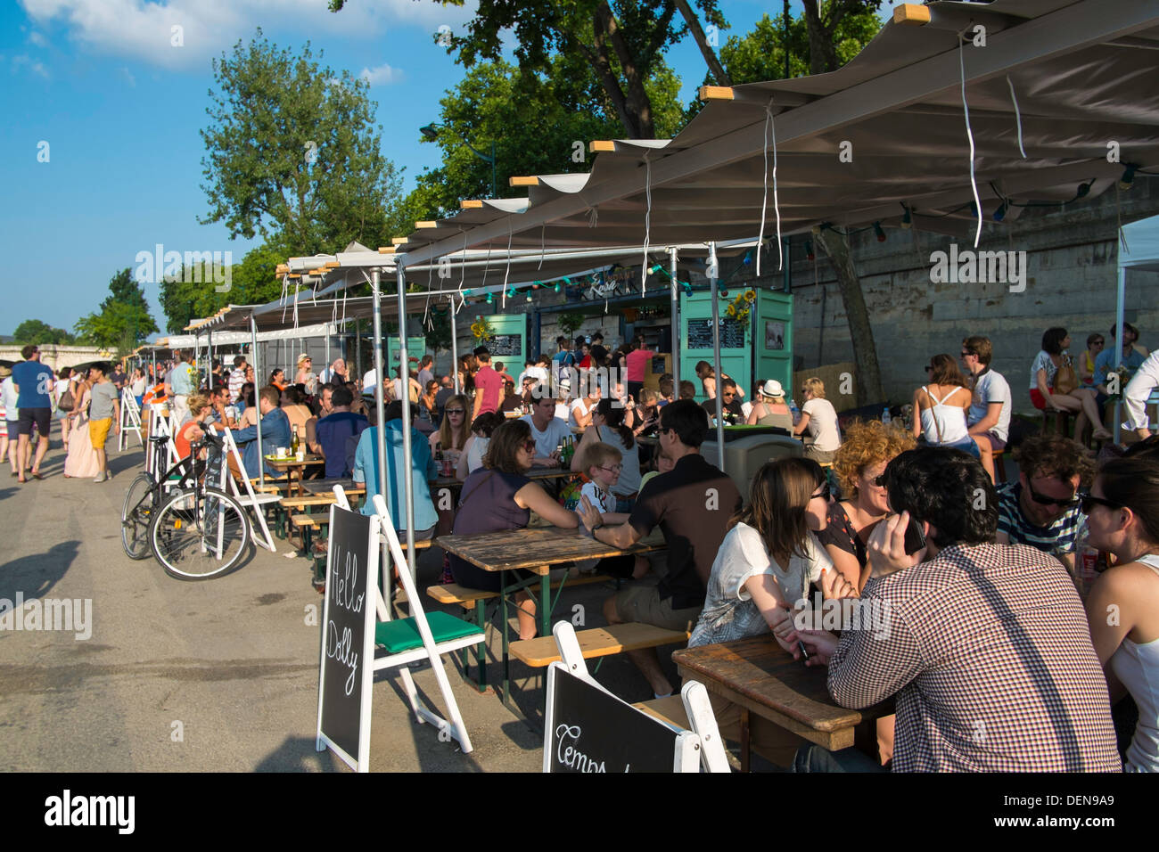 People relaxing at a cafe at Les Berges, along the Seine, Paris, France Stock Photo