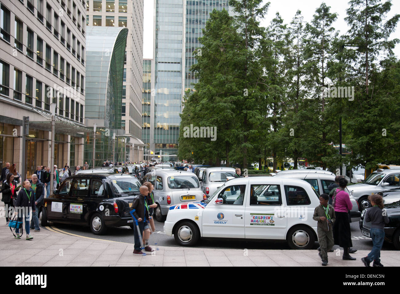 Taxis at Canary Wharf collecting children with life - threatening illnesses to take to Disneyland Paris during the annual event. Stock Photo