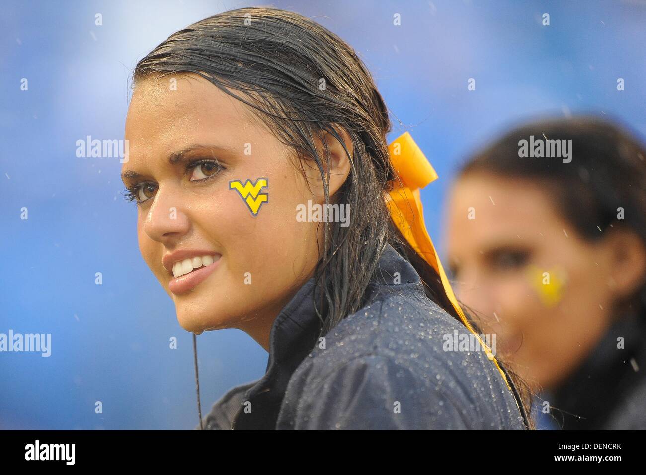 Baltimore, MD, USA. 21st Sep, 2013. A Mountaineer cheerleader watches her team as she gets soaked from the heavy rain during a match up between the Maryland Terrapins and the West Virginia Mountaineers at M&T Bank Stadium in Baltimore, MD. The Terrapins shut out the Mountaineers 37-0. Credit:  Cal Sport Media/Alamy Live News Stock Photo