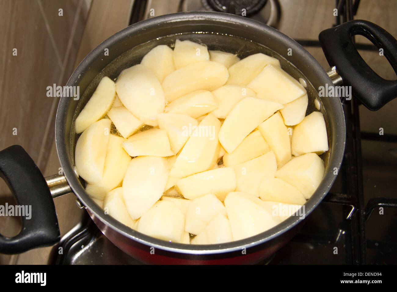 Cooking Potatoes in Cooking Pot Stock Photo