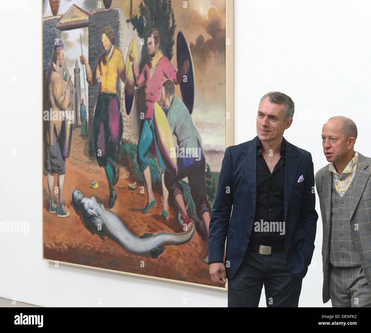 Painter Neo Rauch (L) and gallery owner Gerd Harry Lybke stand next to Rauch's painting 'Speertanz' at gallery Eigen + Art' in Leipzig, Germany, 21 September 2013. The gallery presents Rauch's new works as part of the tour of Spinnerei galleries. Photo: Hendrik Schmidt Stock Photo