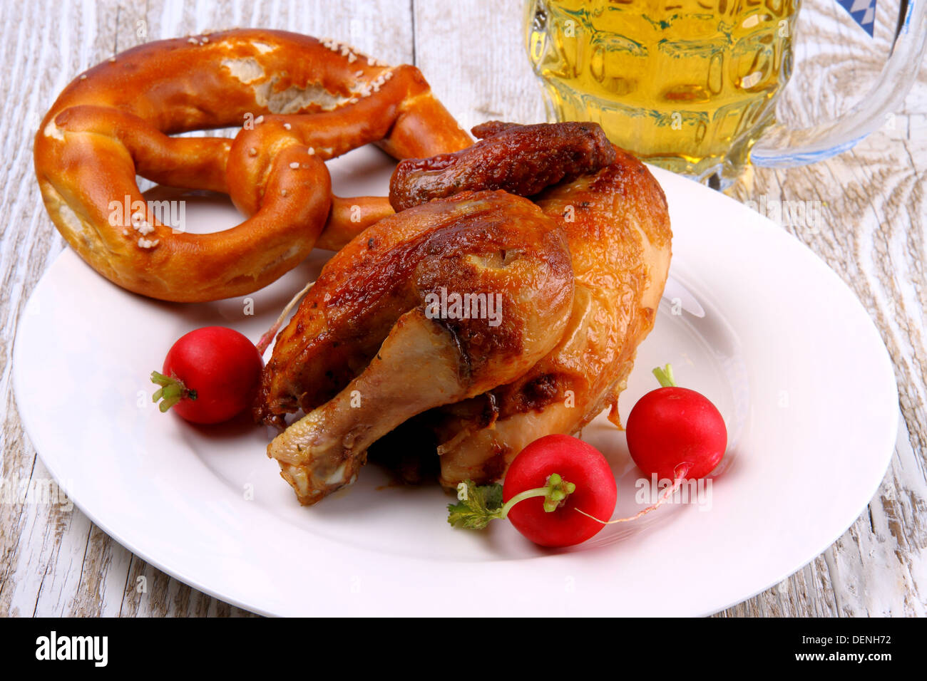Chicken for Oktoberfest with radish, pretzel and beer, close up Stock