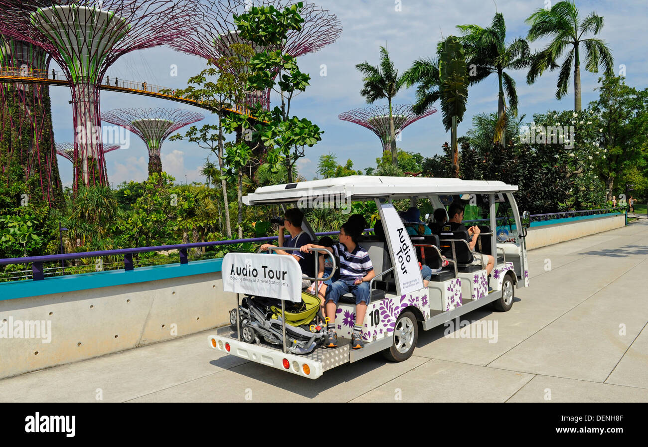 Electric powered audio tour mini-bus taking tourist the Gardens by the Bay  complex. Stock Photo