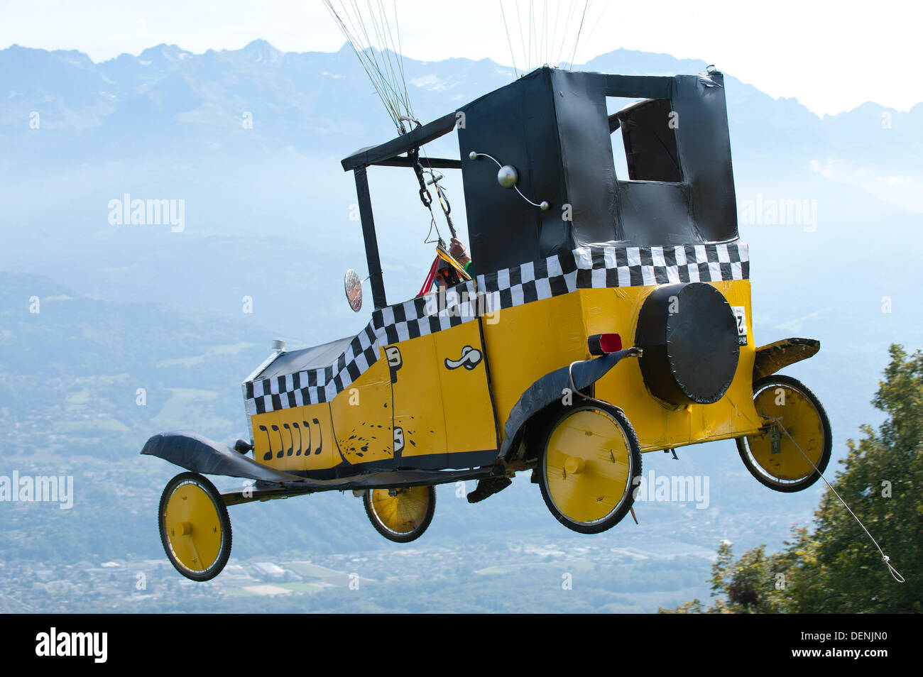 St Hilaire Du Touvet, France. 22nd Sep, 2013. On a perfect late summer day thousands of spectators flock to the spectacle of paraglider pilots taking off from an alpine cliff face dressed up in elaborate fancy dress. Photo credit: Graham M. Lawrence/Alamy Live News. Stock Photo