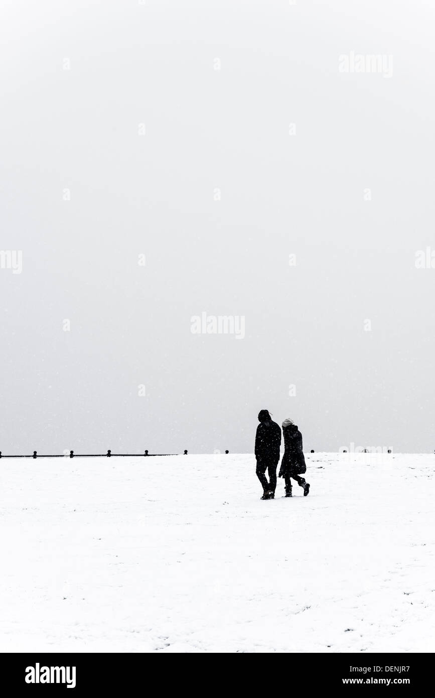couple walking in snow,lytham,lancashire,england,uk,europe Stock Photo
