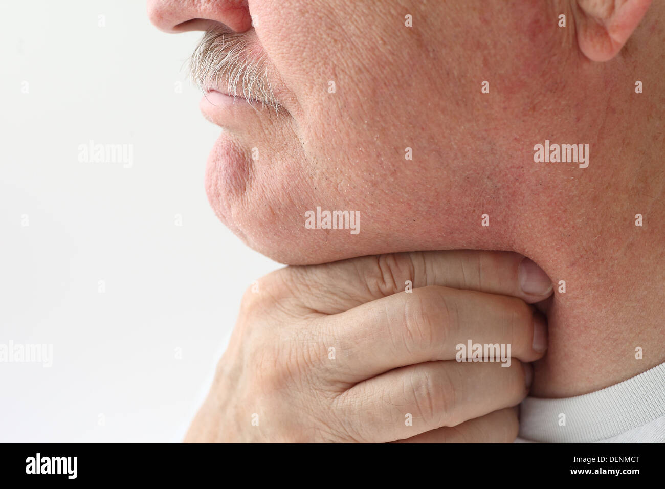 mature man with a very sore throat Stock Photo