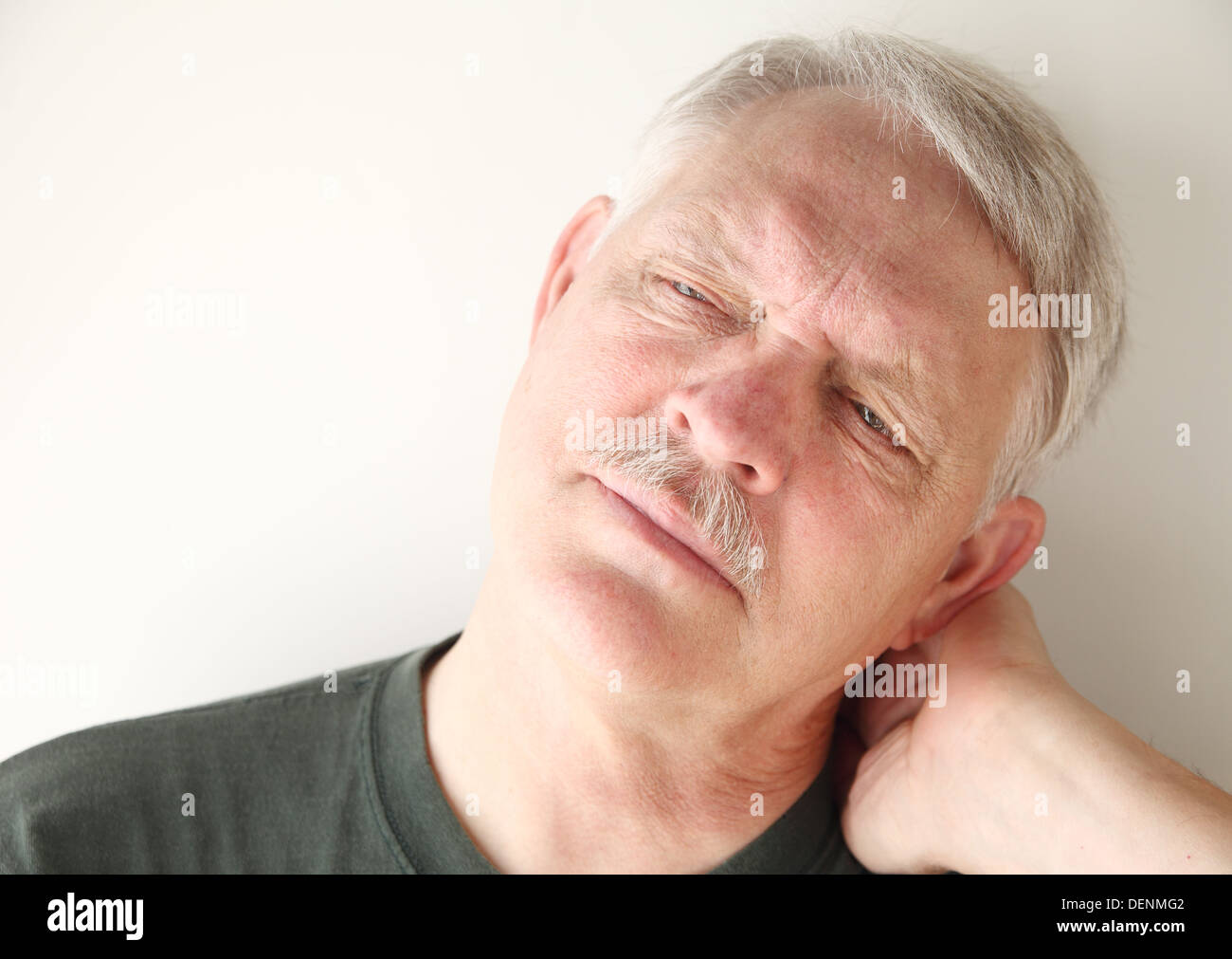 senior man has a painful stiff neck Stock Photo