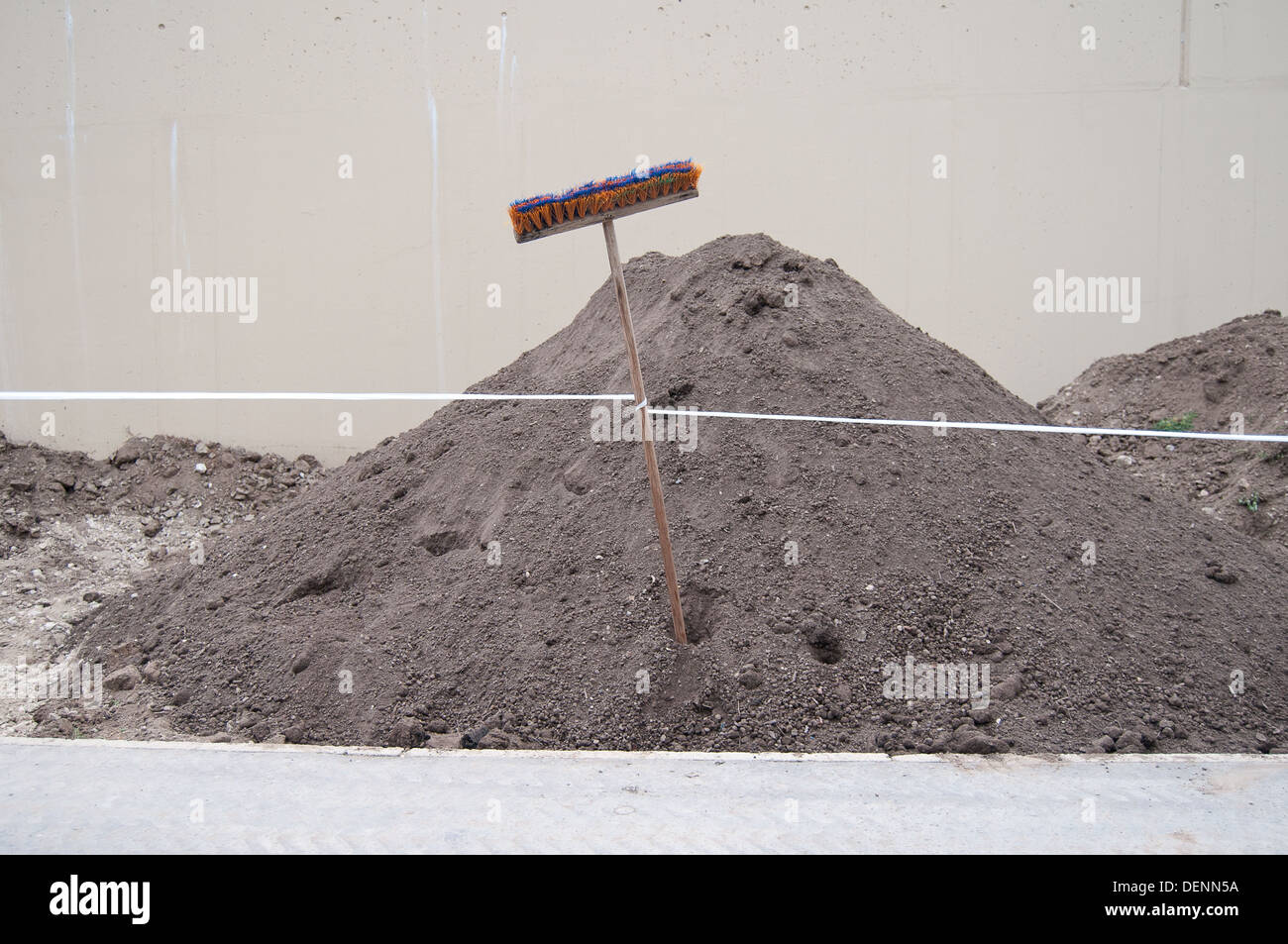 Upside down broom stuck in dirt on roadside Stock Photo Alamy