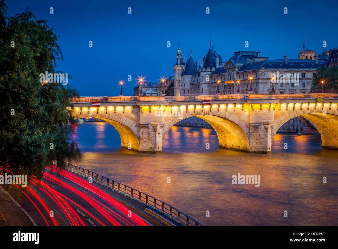 Twilight over Pont Neuf and the Conciergerie along River Seine, Paris France Stock Photo