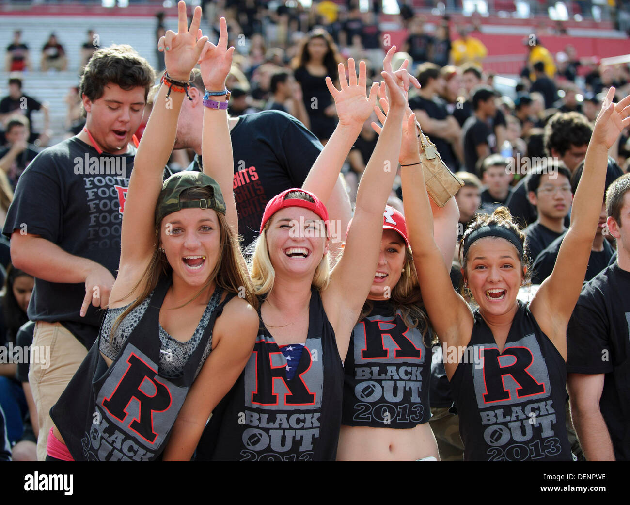 Piscataway, New Jersey, USA. 21st Sep, 2013. September 21, 2013: Attractive RU black out super fans of the Rutgers Scarlet Knights wave and cheer during the game between Arkansas Razorbacks and Rutgers Scarlet Knights at Highpoint Solutions Stadium in Piscataway, NJ. Rutgers Scarlet Knights defeated The Arkansas Razorbacks 28-24. © csm/Alamy Live News Stock Photo