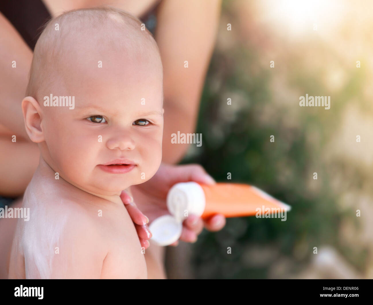 Caucasian mom does sunblock on her baby in the air Stock Photo Alamy